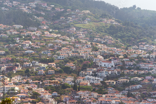 houses on the steep slopes of the city of Funchal, capital of the Portuguese island of Madeira © villorejo