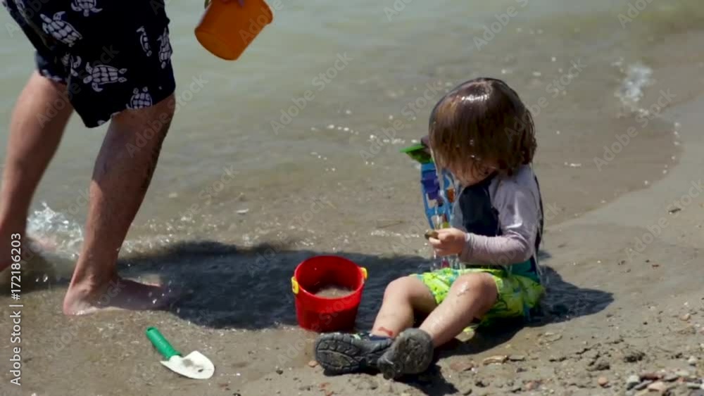 Father Pours A Bucket Of Water On His Son's Head, His Son Smiles And Laughs, Slow Motion