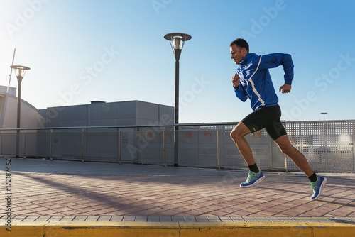Valokuva Handsome man running in the city.