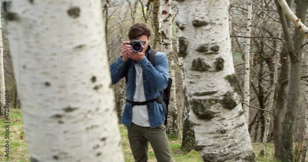 man in woods looking and shoot photos in camera.Following side.Real people Millennial traveller backpacker adult male photographer walking on rural field to shoot photographs in autumn season.4k video man in woods looking and shoot photos in camera.Following side.Real people Millennial traveller backpacker adult male photographer walking on rural field to shoot photographs in autumn season.4k video