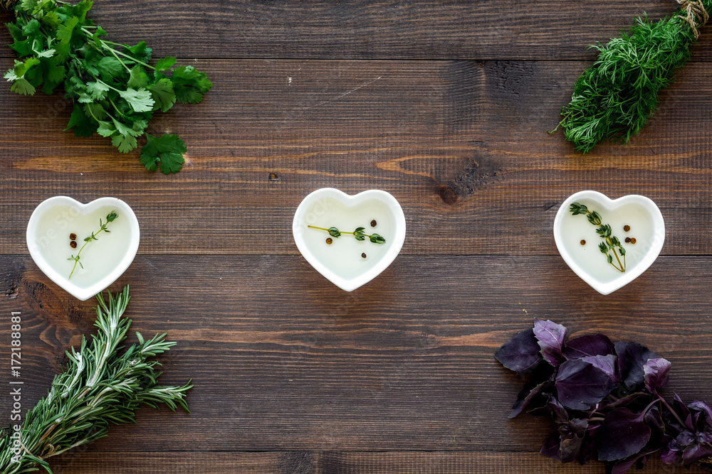 greenery with natural oil for cooking on wooden kitchen table background top view greenery with natural oil for cooking on wooden kitchen table background top view