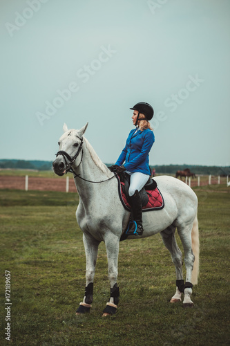 Middle-aged woman riding her horse © Nejron Photo