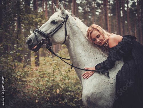 Romantic middle-aged woman with her horse