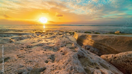 Wallpaper Mural Beautiful sea timelapse of the coast rocks beach sunset on Bali in Indonesia. Torontodigital.ca