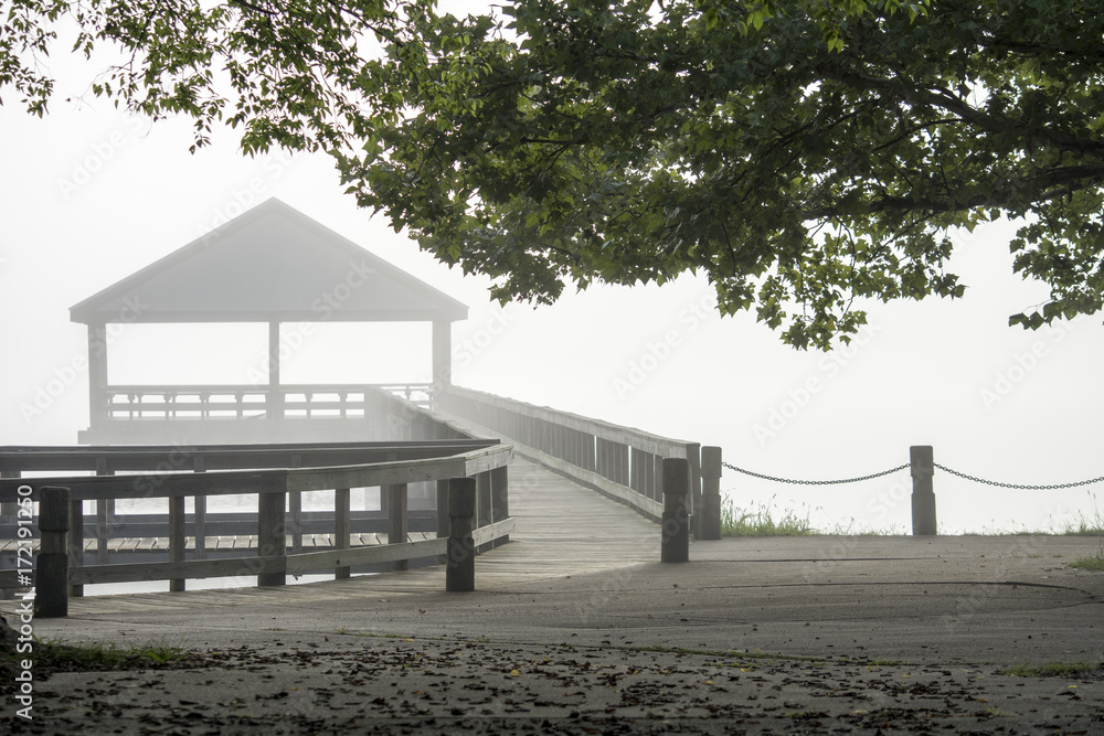 Pavilion and pier appear in the mist 
