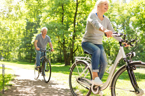 Senior Couple Riding Bikes In Park