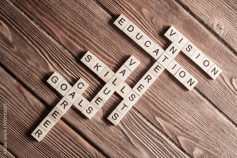 Conceptual keywords on wooden table with elements of game making crossword Conceptual keywords on wooden table with elements of game making crossword