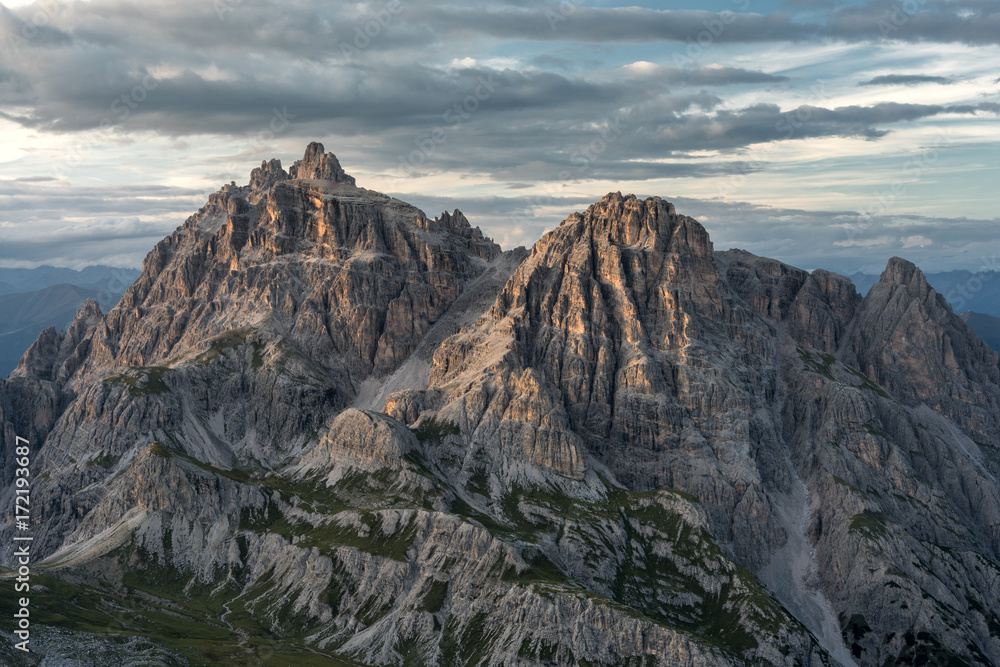 Scenic view of mountain range against cloudy sky
