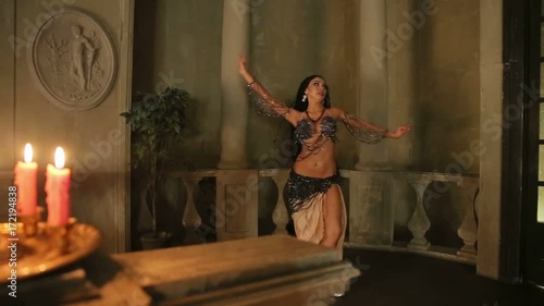 Bellydancer with candles and in beautiful clothes photo