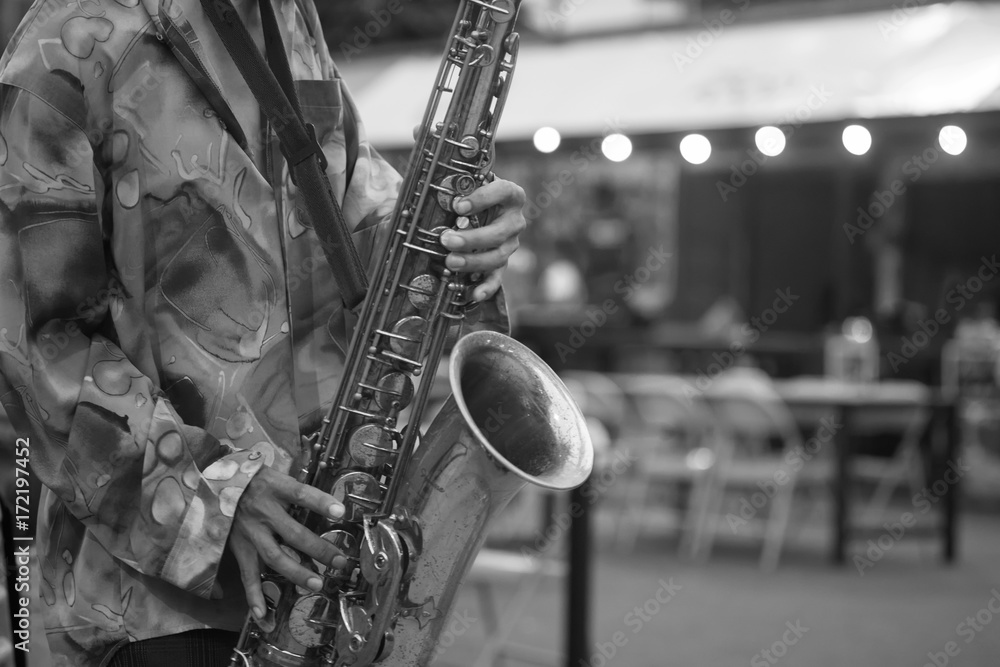 Obraz premium man live music on street with playing trumpet, musical instruments with monochrome black and white tone.