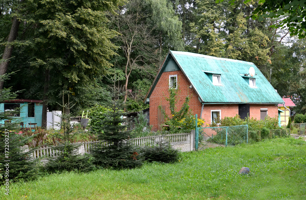Fototapeta premium Brick lodge on the seasonal dacha about the wood