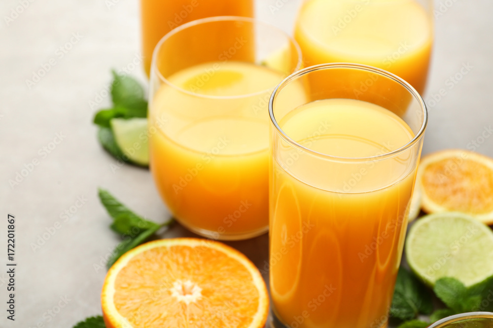 Glasses of fresh orange juice on table, closeup Glasses of fresh orange juice on table, closeup