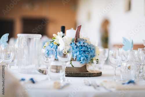 Floral centrepiece surrounded by empty glasses