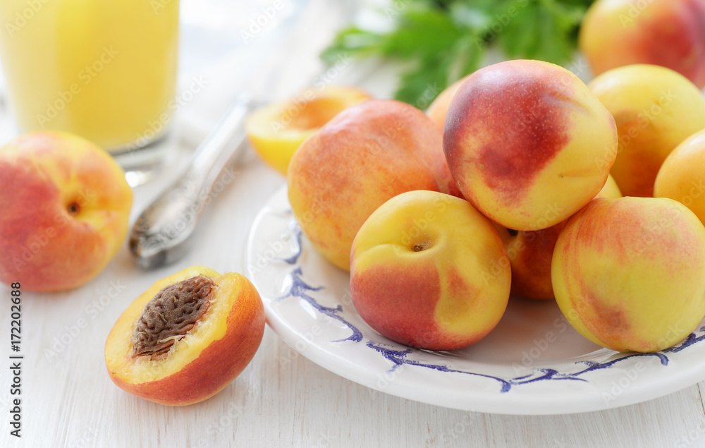 Fresh ripe nectarines on white wooden table Fresh ripe nectarines on white wooden table