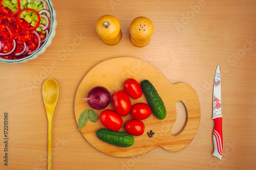 salad of cucumber and tomato cooking, cutting board