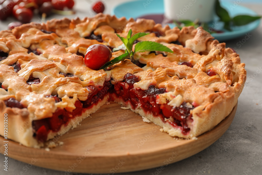 Sliced delicious cherry pie on wooden board Sliced delicious cherry pie on wooden board