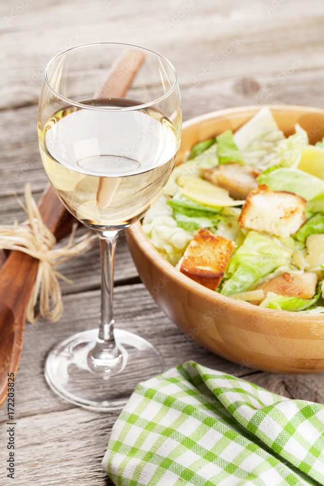 White wine glass and caesar salad White wine glass and caesar salad