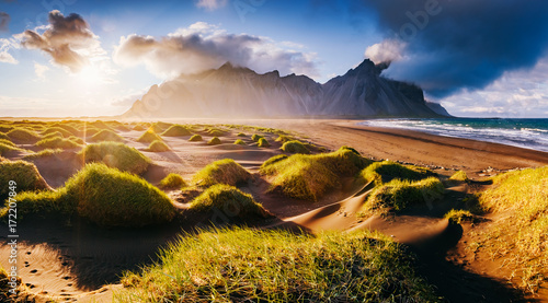 Beautiful view of the yellow hills glowing by sunlight. Location place Stokksnes cape, Vestrahorn, Iceland, Europe. © Leonid Tit