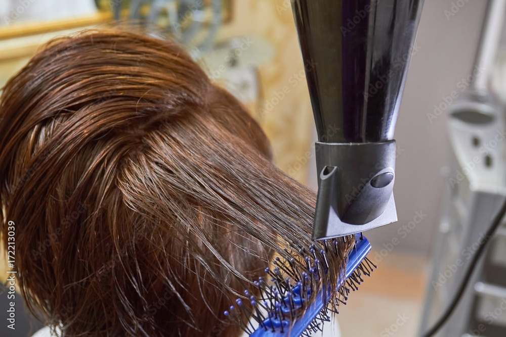 Fototapeta premium Hair and blow dryer. Work of a hairdresser. Hair drying tips for volume.