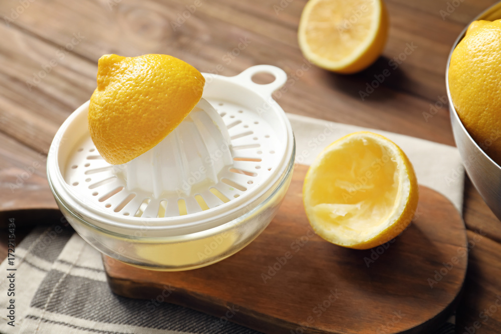 Lemon squeezer on wooden table Lemon squeezer on wooden table
