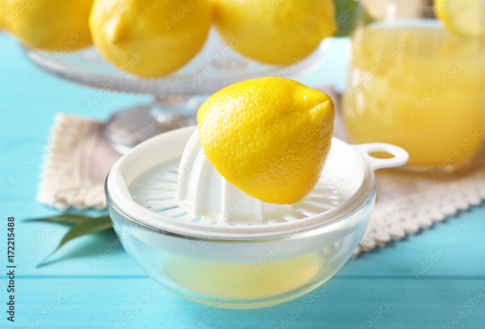 Lemon squeezer on color wooden table Lemon squeezer on color wooden table