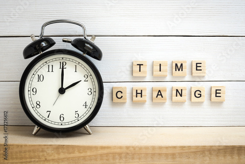 Daylight Saving Time Concept Represented with a Vintage Alarm Clock and Wooden Letters