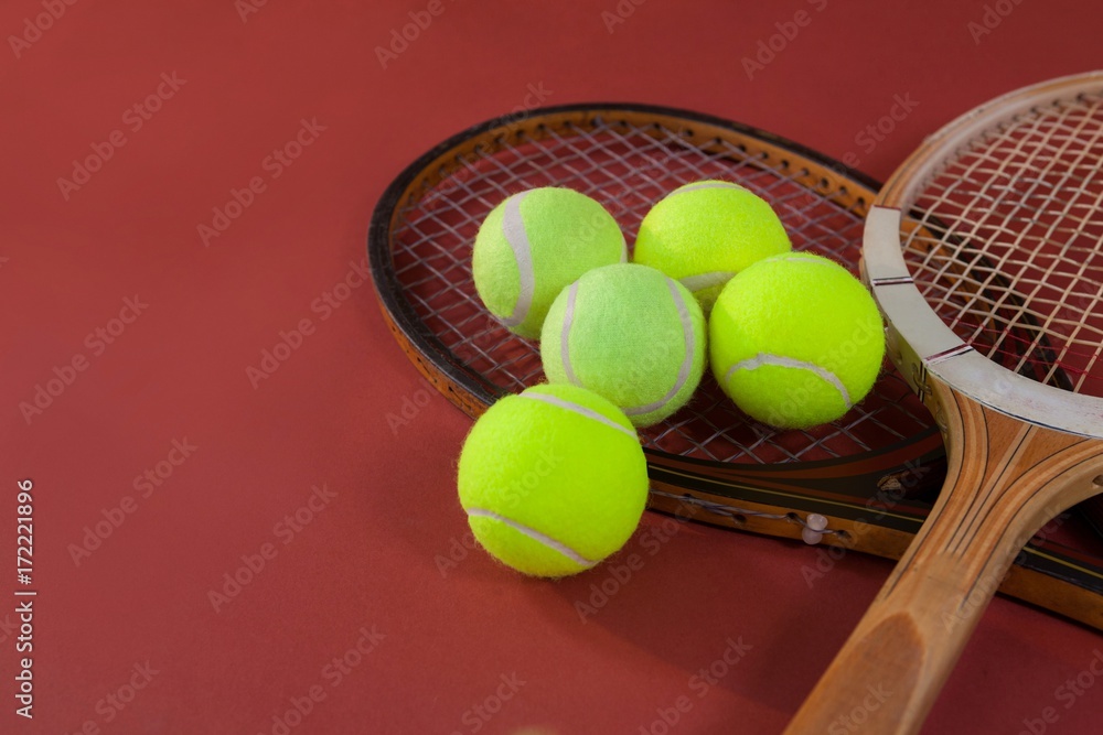 High angle view of tennis balls with wooden rackets