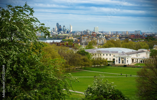 Panoramic view from Greenwich on Canary Wharf financial district with skyscrapers at night. View includes the park, National Maritime Museum and Royal chapel photo