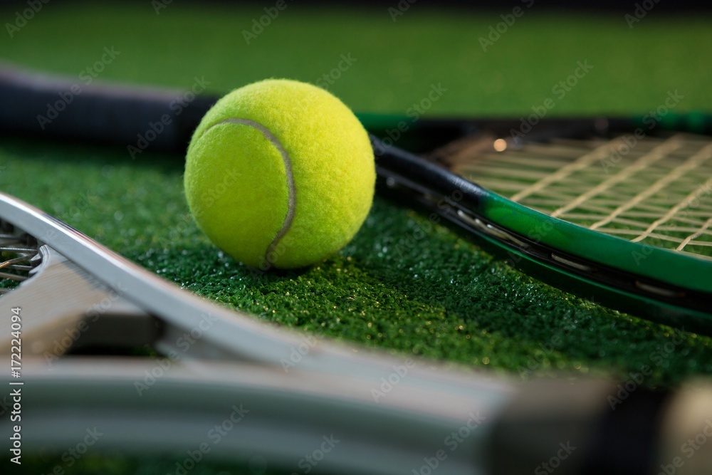 Close up of tennis ball with rackets