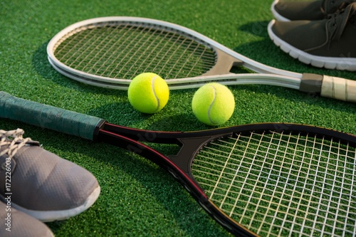 Close up of tennis rackets with balls and sports shoes © WavebreakMediaMicro