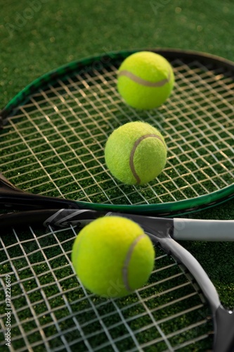 Close up of tennis balls on rackets © WavebreakMediaMicro