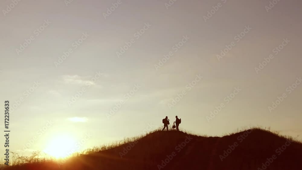 people group of tourists walking on travel top of a sunset silhouette mountain. slow video tourists people group go nature people group of tourists walking on travel top of a sunset silhouette mountain. slow video tourists people group go nature