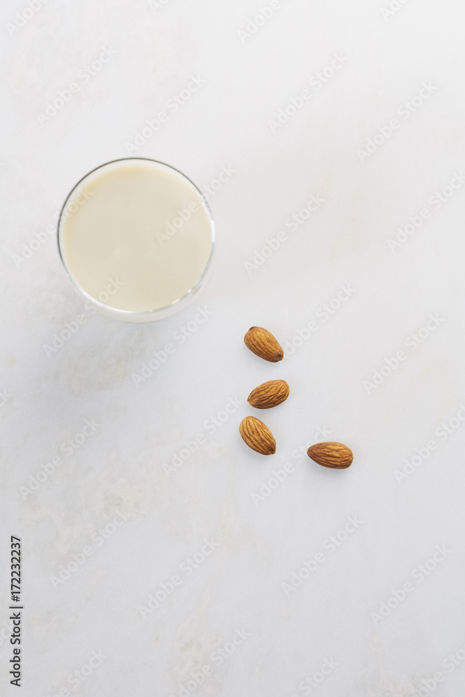 Glass of almond milk with whole almonds Glass of almond milk with whole almonds