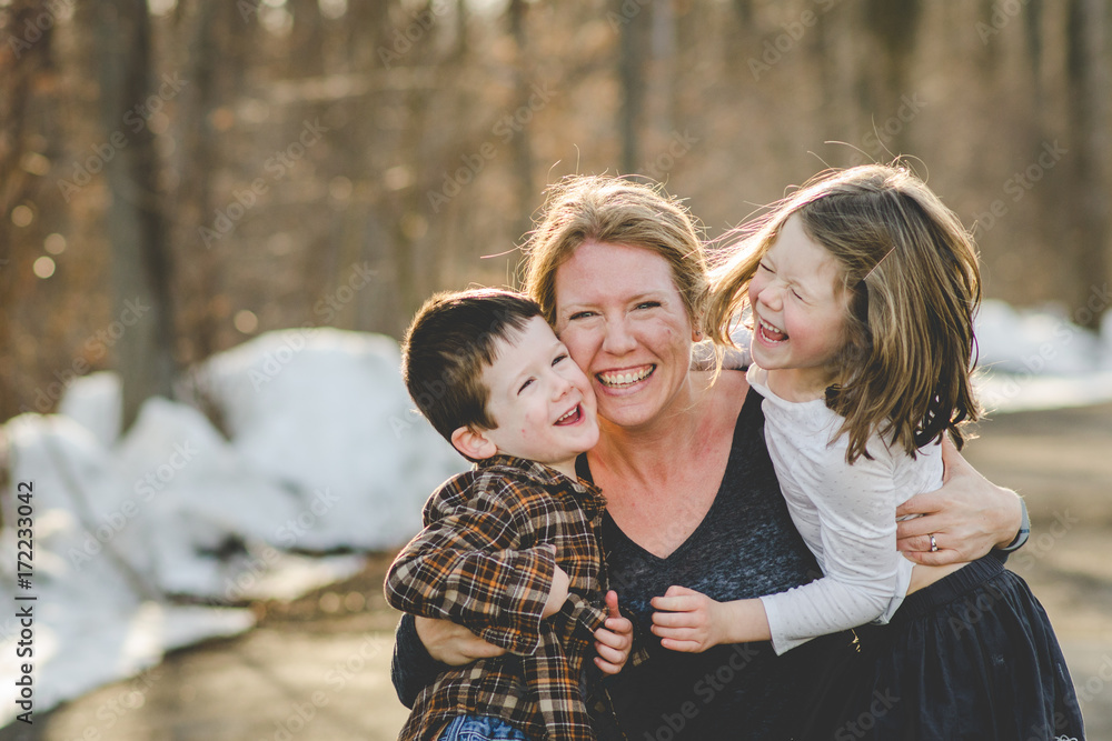 Mom tickling happy kids at the park Mom tickling happy kids at the park