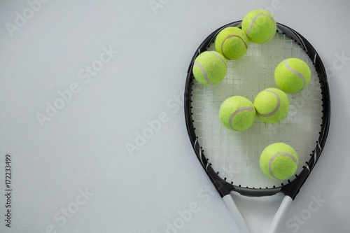Overhead view of tennis balls on racket © WavebreakMediaMicro