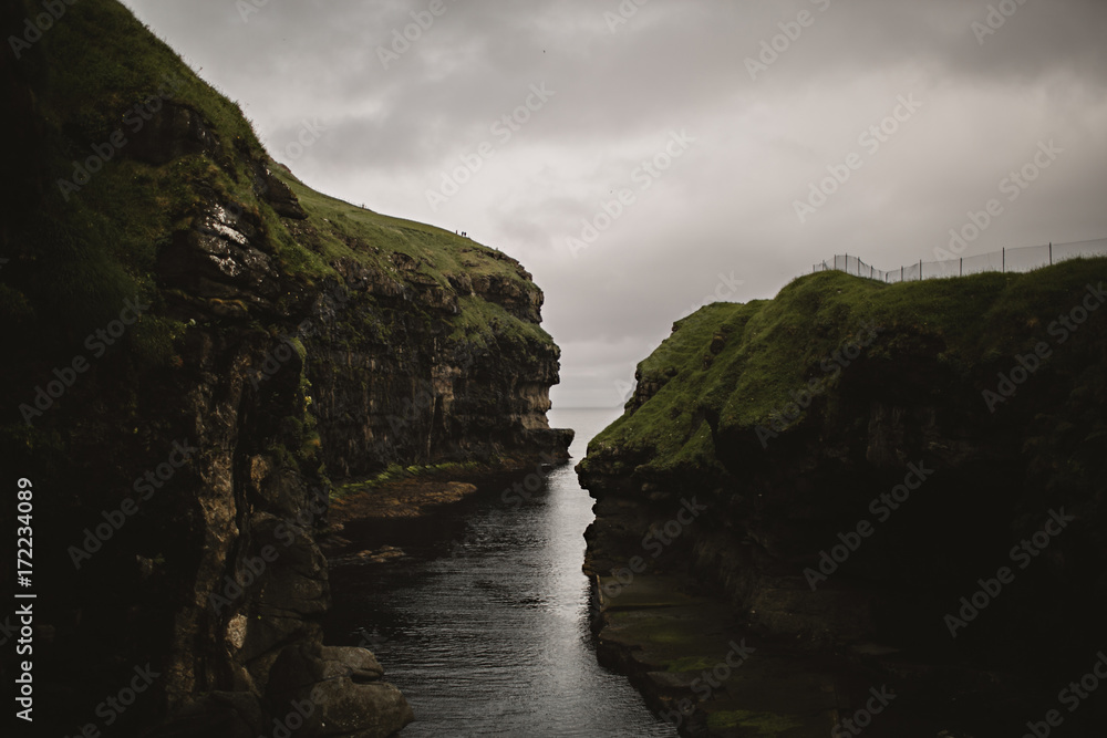 Natural Harbor and Cliffs on the Atlantic Ocean in Gjogv, Faroe Islands Natural Harbor and Cliffs on the Atlantic Ocean in Gjogv, Faroe Islands