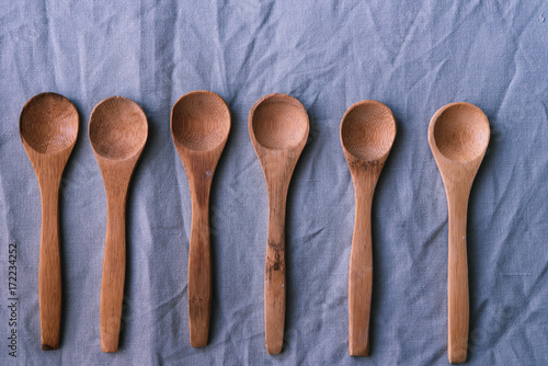 Wooden spoons on a blue backgrownd photo