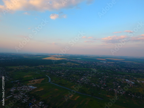 Aerial view of beautiful village, houses, roads. Sky, clouds.