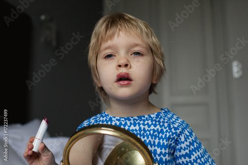 A first attempt to apply lipstick.