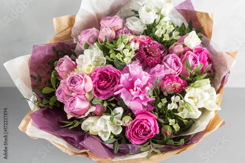 luxurious and elegant bouquet of roses and Other flowers. Composition colors on gray background. Copy space.