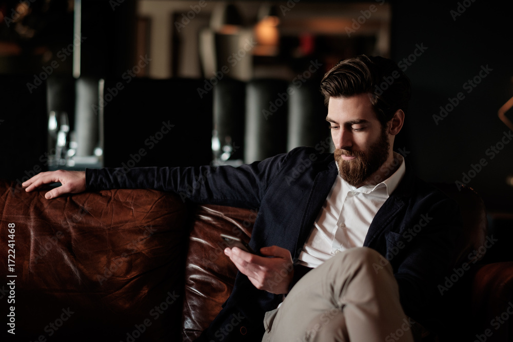 Handsome bearded man using phone Handsome bearded man using phone