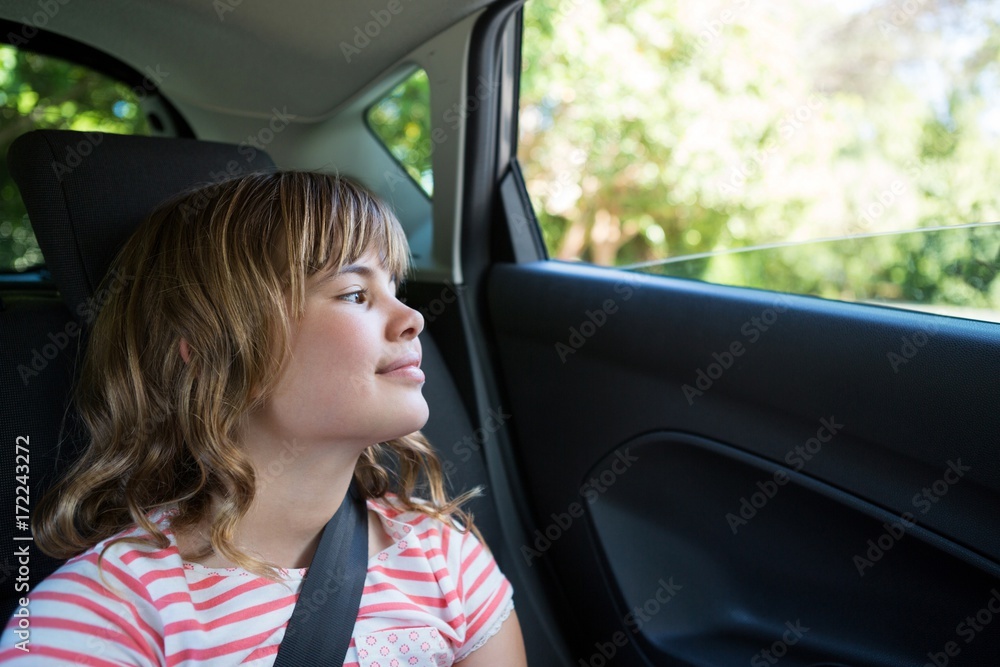 Teenage girl sitting in the back seat of car Teenage girl sitting in the back seat of car