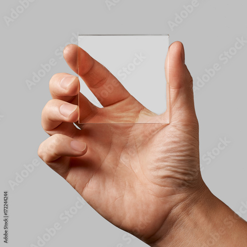 close-up of a hand holding a transparent glass