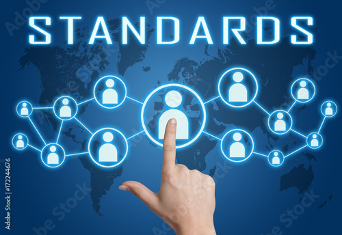 Standards - text concept with hand pressing social icons on blue world map background.