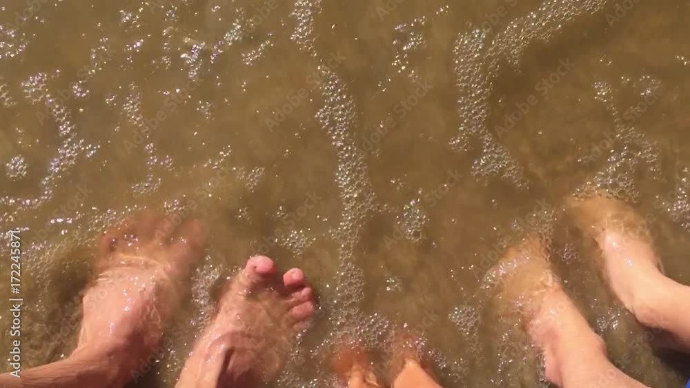 boy water girl and man family legs in the ocean slow motion video. strong waves of sand sea rest family boy water girl and man family legs in the ocean slow motion video. strong waves of sand sea rest family