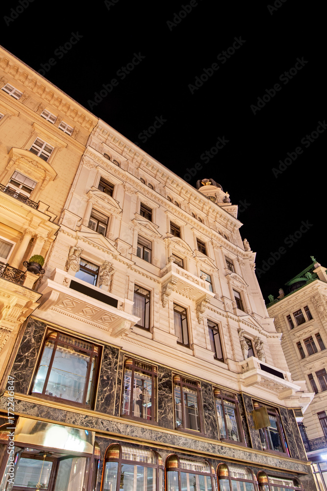 Low angle view of historic illuminated building at night between Graben, Stephansplatz and Seilergasse at Vienna, Austria