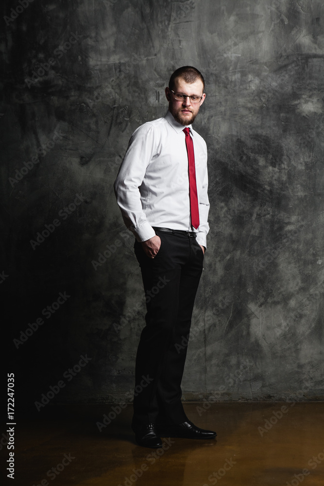 young man in glasses standing in white shirt young man in glasses standing in white shirt