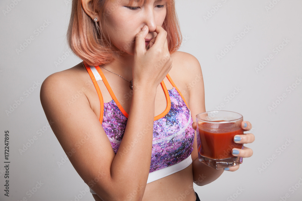 Beautiful healthy Asian girl hate tomato juice. Beautiful healthy Asian girl hate tomato juice.