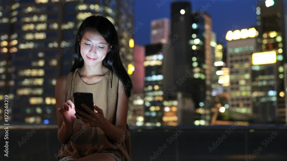 Woman using smart phone in Hong Kong Woman using smart phone in Hong Kong