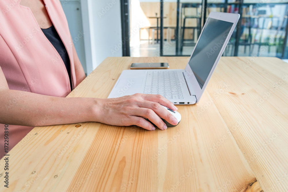 Fototapeta premium female hands working with a laptop in office at desk